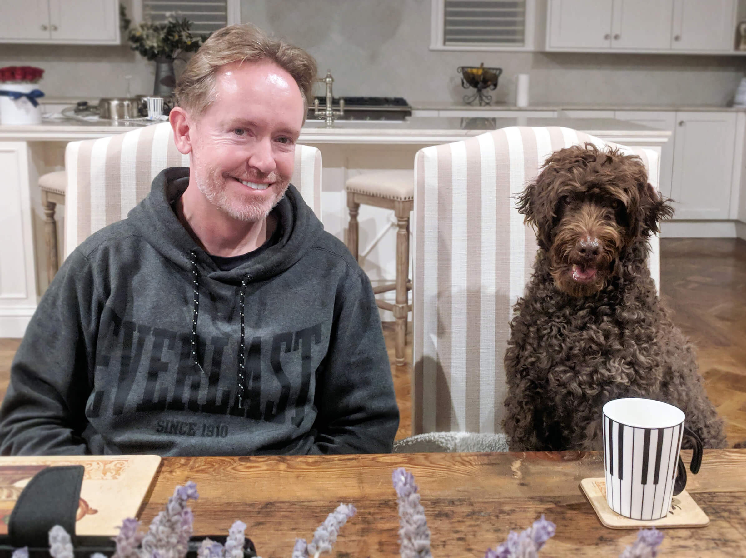 Hugo the dog with owner at table